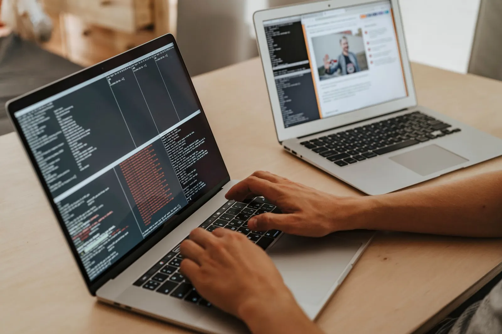 A developer writing code on a laptop